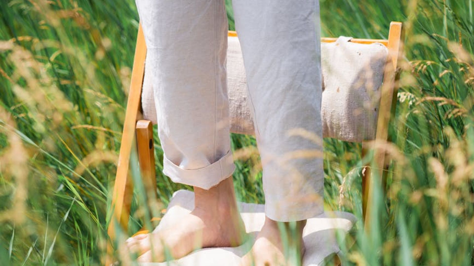 Person looking calmly into the distance in a green field.